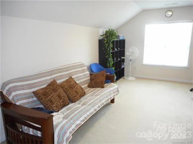 a bed sitting in a bedroom next to a window