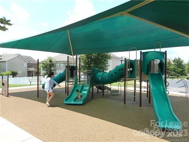 a view of a patio with a table and chairs under an umbrella