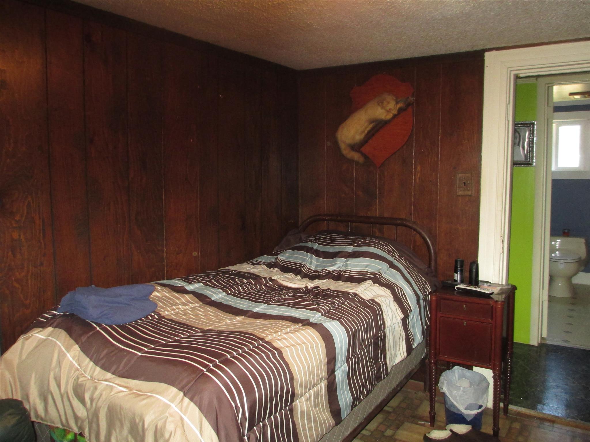 1935 Chicken Road Lebanon, TN 37090 - Photo 18 of 28 a bedroom with a bed and wooden floor