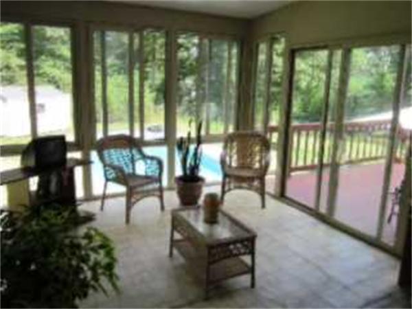 7 Rivers Edge Way Freetown, MA 02702 - Photo 20 of 25 a living room filled with furniture and a floor to ceiling window