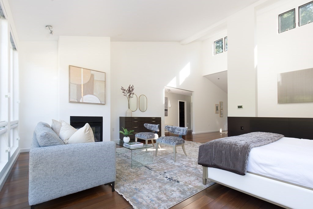 83 McAllister Drive Carlisle, MA 01741 - Photo 14 of 30 a bedroom with furniture and a fireplace