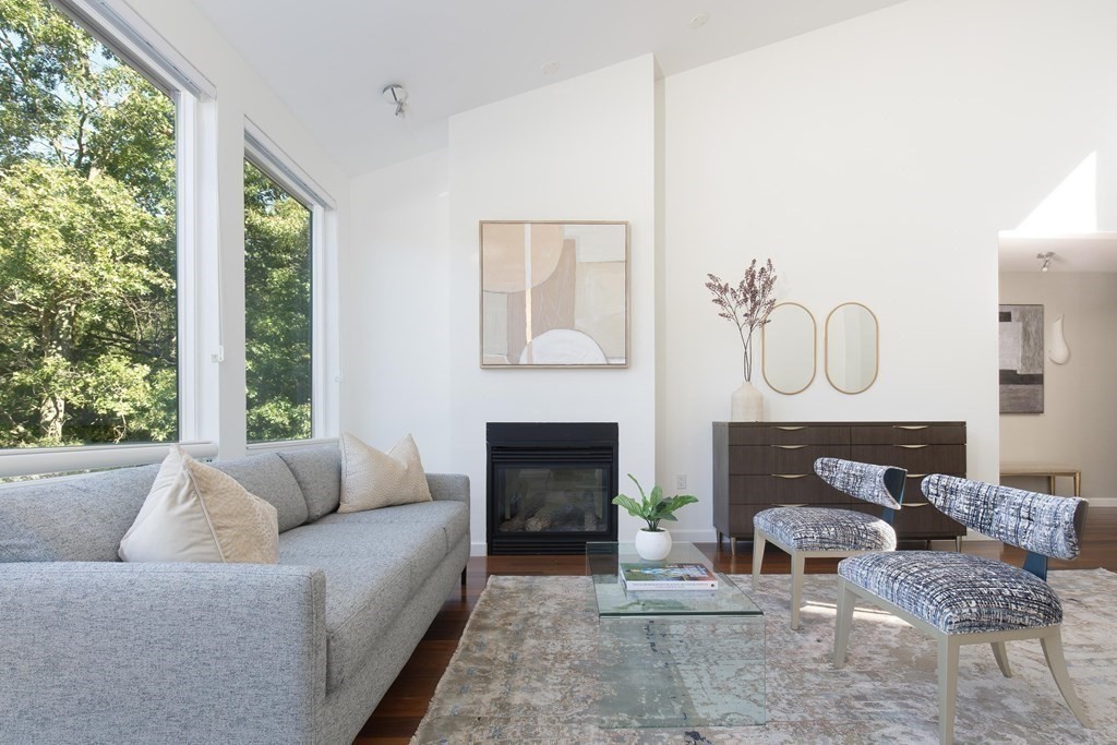 83 McAllister Drive Carlisle, MA 01741 - Photo 15 of 30 a living room with furniture a fireplace and window