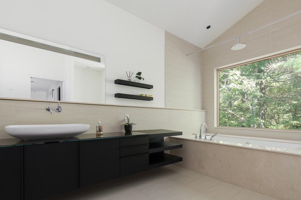 83 McAllister Drive Carlisle, MA 01741 - Photo 17 of 30 a bathroom with a double vanity sink window and mirror