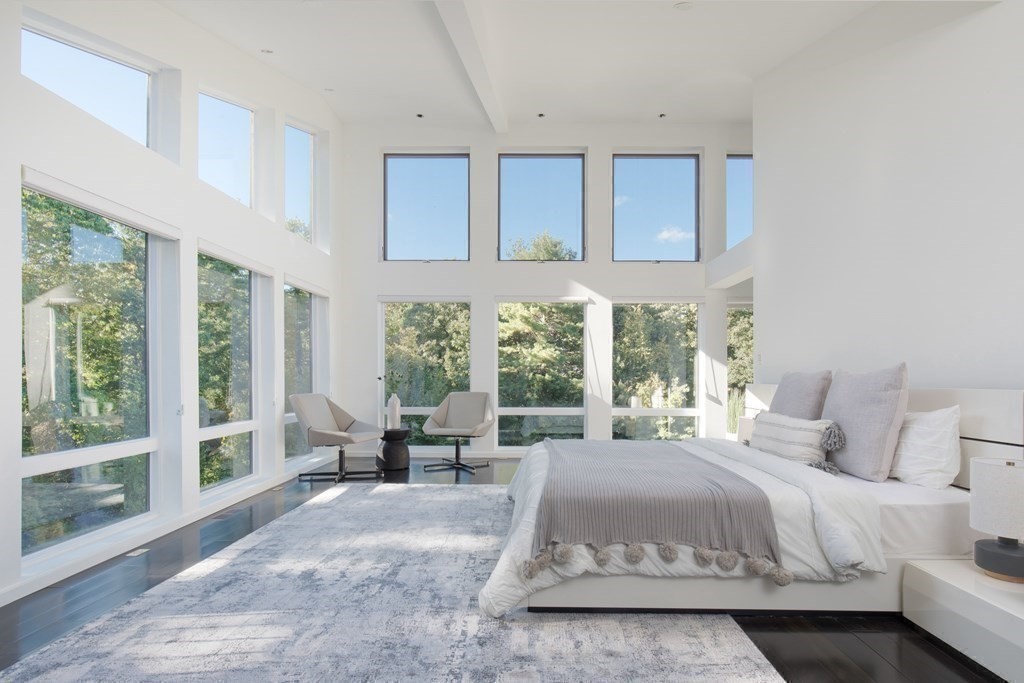 83 McAllister Drive Carlisle, MA 01741 - Photo 20 of 30 a bedroom with a large bed and large windows