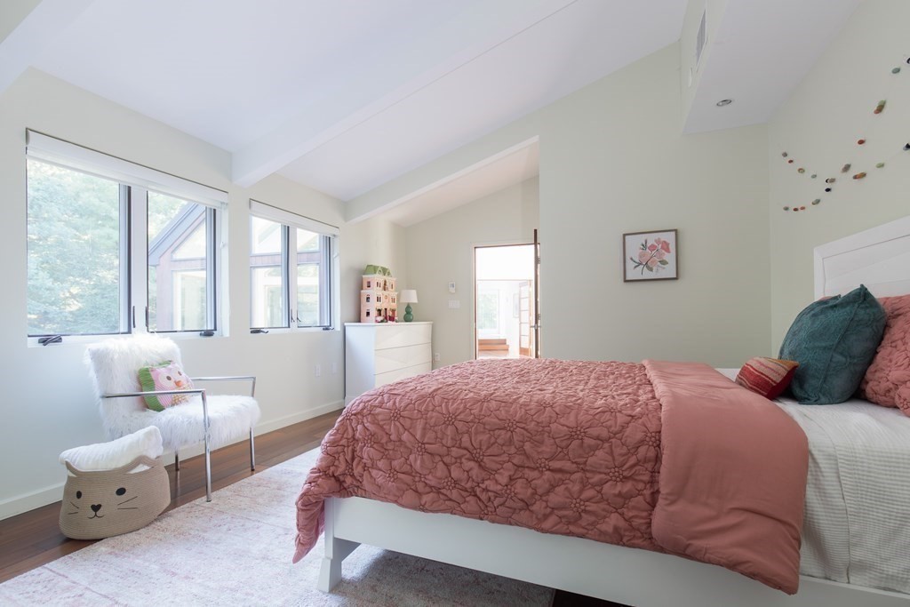 83 McAllister Drive Carlisle, MA 01741 - Photo 23 of 30 a bedroom with a large bed and a window