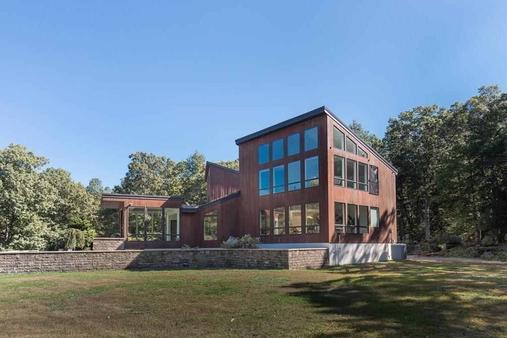83 McAllister Drive Carlisle, MA 01741 - Photo 29 of 30 a front view of a building with a garden