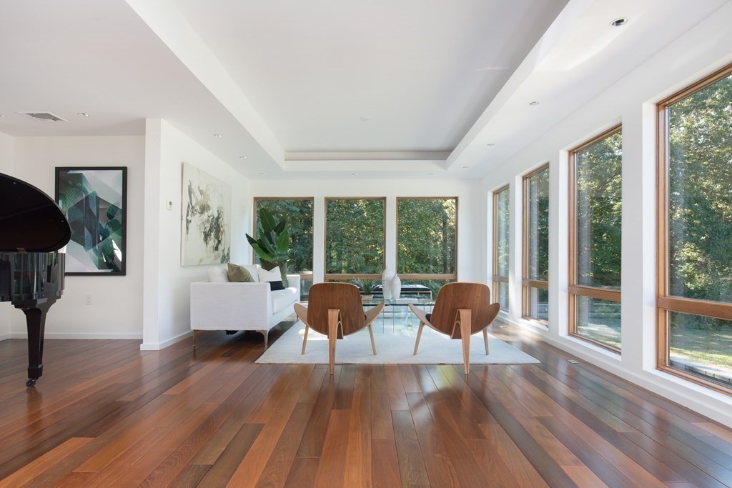 83 McAllister Drive Carlisle, MA 01741 - Photo 5 of 30 a living room with furniture and large windows