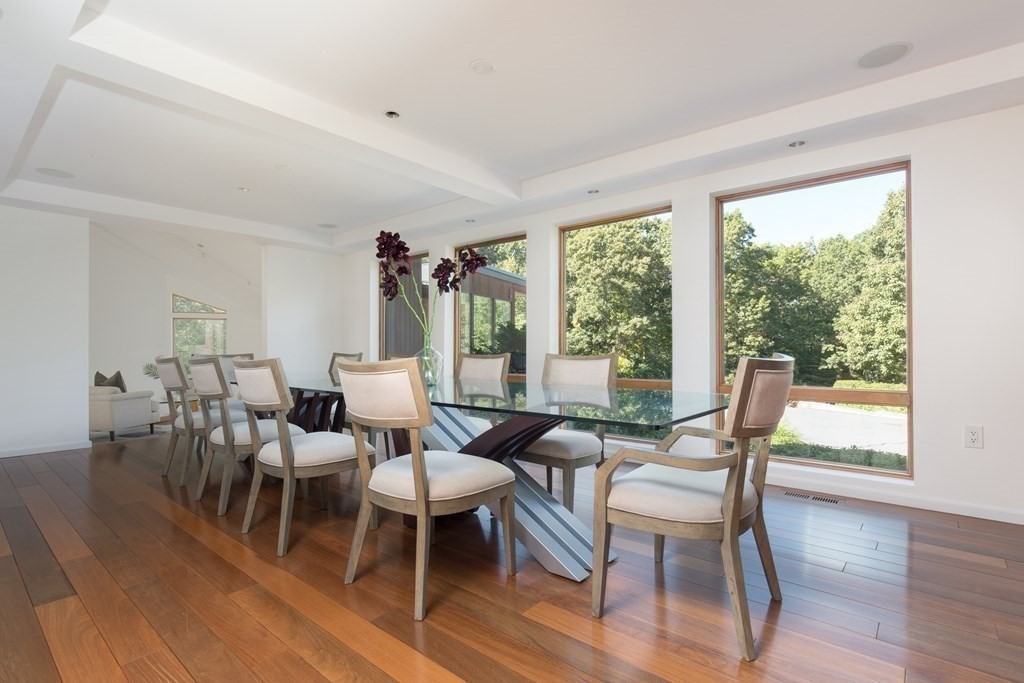 83 McAllister Drive Carlisle, MA 01741 - Photo 8 of 30 a view of a dining room with furniture window and wooden floor
