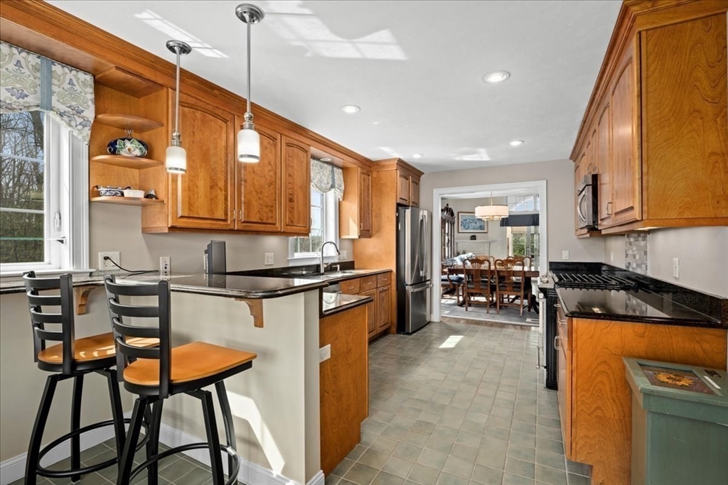 7 Primmett Lane, Unit 7 Worcester, MA 01609 - Photo 4 of 38 a kitchen with sink refrigerator and cabinets