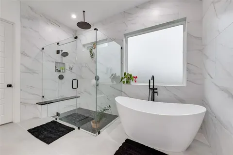 a bathroom with a bathtub and shower