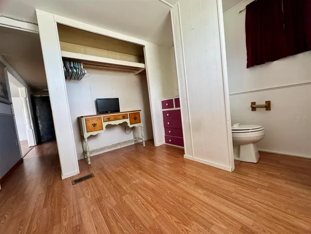 a view of room with wooden floor and chair
