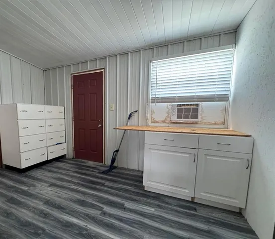 a kitchen with cabinets appliances and a window
