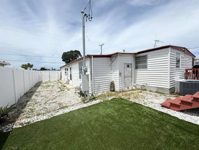 a view of a house with backyard and a chair