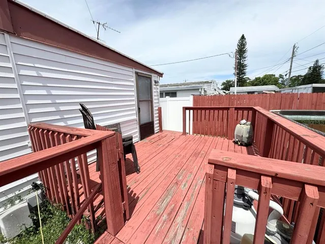 a view of a balcony with wooden floor