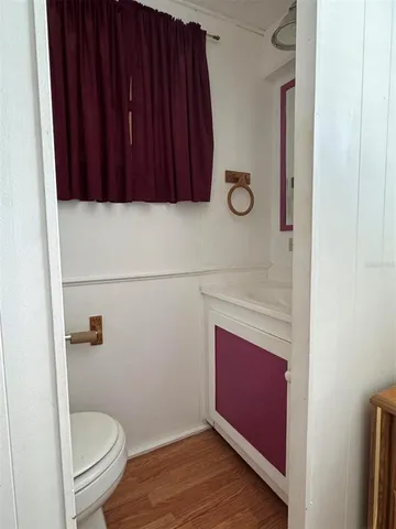a bathroom with a toilet a sink and vanity