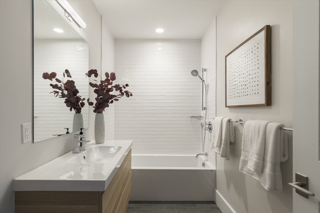 11 Tannery Brook Row, Unit 2 Somerville, MA 02144 - Photo 15 of 17 a bathroom with a sink tub and a mirror
