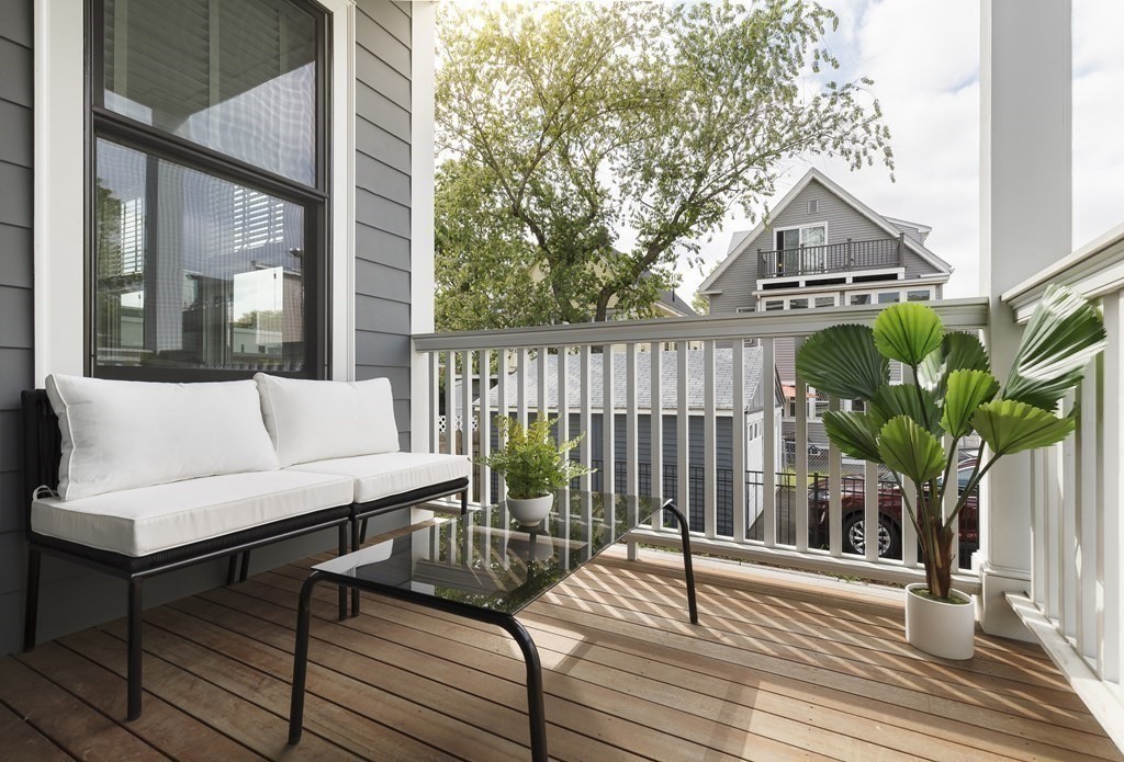 11 Tannery Brook Row, Unit 2 Somerville, MA 02144 - Photo 16 of 17 a view of a deck with couches and wooden floor