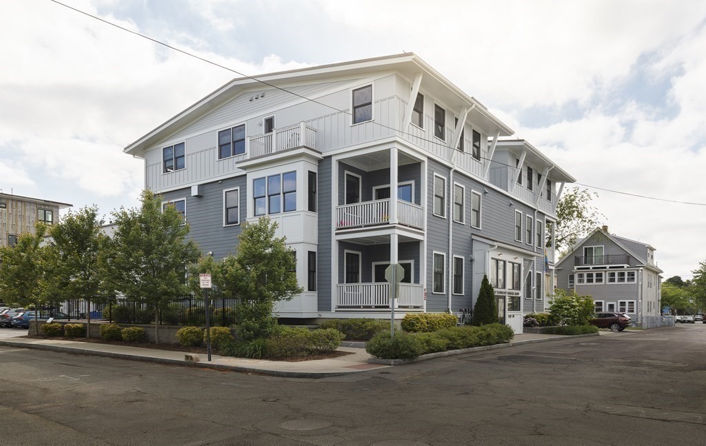 11 Tannery Brook Row, Unit 2 Somerville, MA 02144 - Photo 17 of 17 a front view of a building with a garden