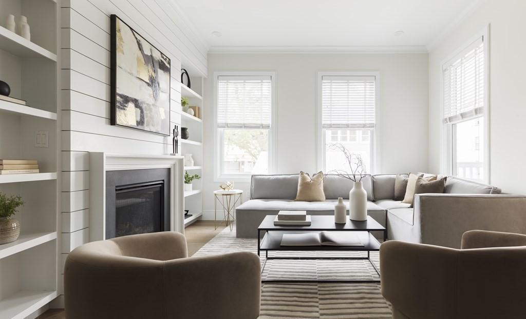 11 Tannery Brook Row, Unit 2 Somerville, MA 02144 - Photo 5 of 17 a living room with furniture a large window and a fireplace