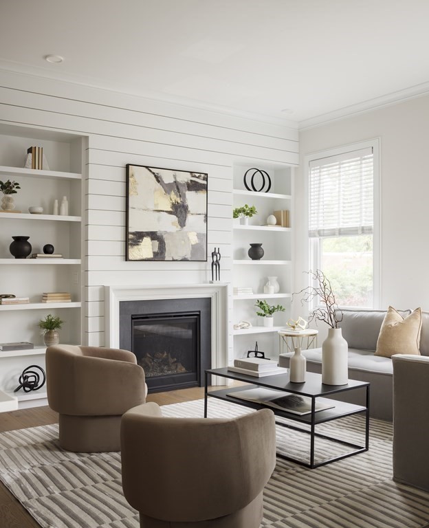 11 Tannery Brook Row, Unit 2 Somerville, MA 02144 - Photo 6 of 17 a living room with furniture and a fireplace