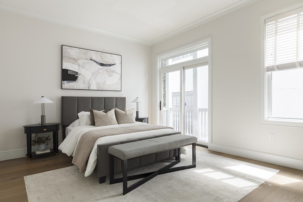 11 Tannery Brook Row, Unit 2 Somerville, MA 02144 - Photo 8 of 17 a bedroom with a bed and a window