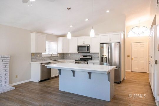 1012 Conejo Avenue Ridgecrest, CA 93555 - Photo 6 of 24 a kitchen with stainless steel appliances a sink stove refrigerator and cabinets