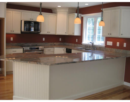 5 Reed Lane Littleton, MA 01460 - Photo 2 of 20 a kitchen with stainless steel appliances granite countertop a sink a stove and a microwave oven