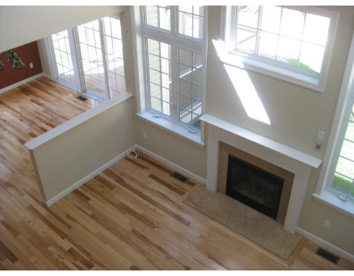 5 Reed Lane Littleton, MA 01460 - Photo 3 of 20 a view of an empty room with wooden floor and a window