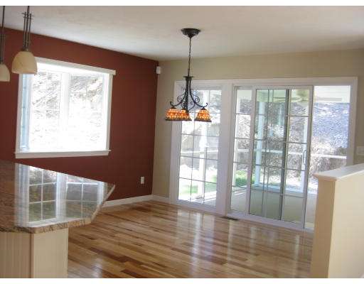 5 Reed Lane Littleton, MA 01460 - Photo 4 of 20 a view of an empty room with wooden floor and a window