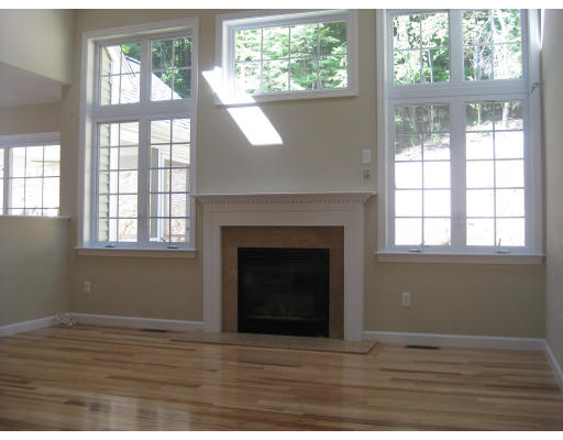 5 Reed Lane Littleton, MA 01460 - Photo 7 of 20 a view of an empty room with wooden floor and a window