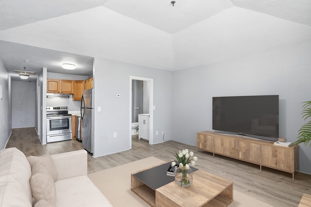 531 Main Street, Unit 410M Worcester, MA 01608 - Photo 1 of 32 a living room with furniture and a flat screen tv