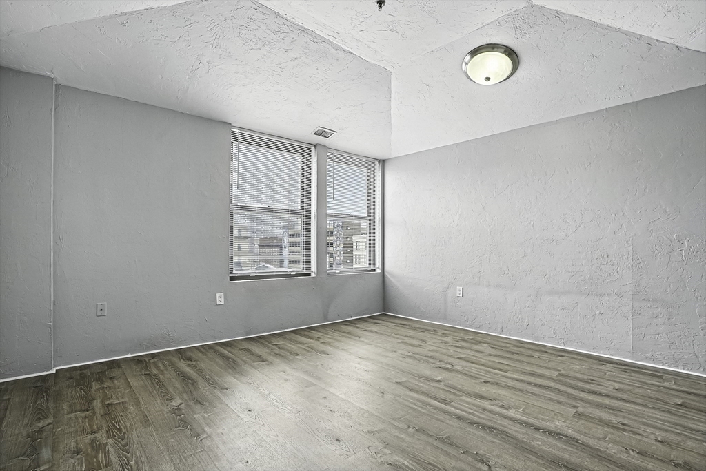 531 Main Street, Unit 410M Worcester, MA 01608 - Photo 12 of 29 wooden floor in an empty room with a window