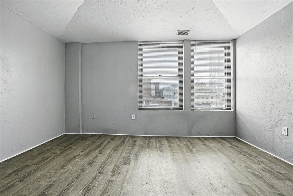 531 Main Street, Unit 410M Worcester, MA 01608 - Photo 14 of 29 an empty room with wooden floor and windows