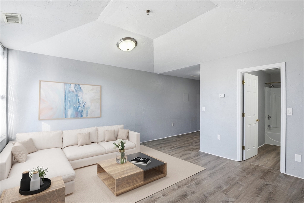 531 Main Street, Unit 410M Worcester, MA 01608 - Photo 3 of 32 a living room with furniture and wooden floor
