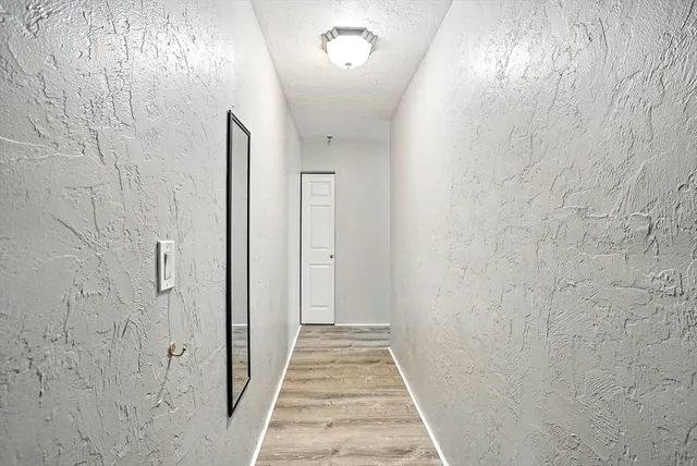 a kitchen with a refrigerator a stove top oven and cabinets