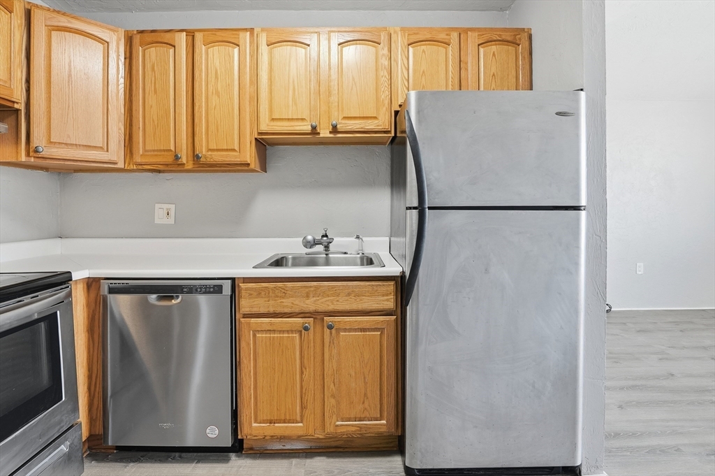 531 Main Street, Unit 410M Worcester, MA 01608 - Photo 10 of 32 a white refrigerator freezer sitting inside of a kitchen