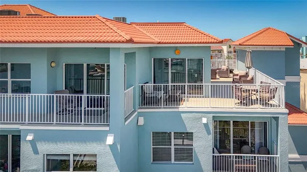 a view of a balcony with a table and chairs