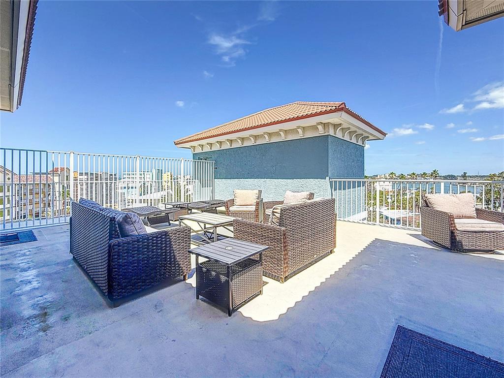 13999 Gulf Boulevard, Unit 501 Madeira Beach, FL 33708 - Photo 12 of 58 a living room with furniture and a flat screen tv