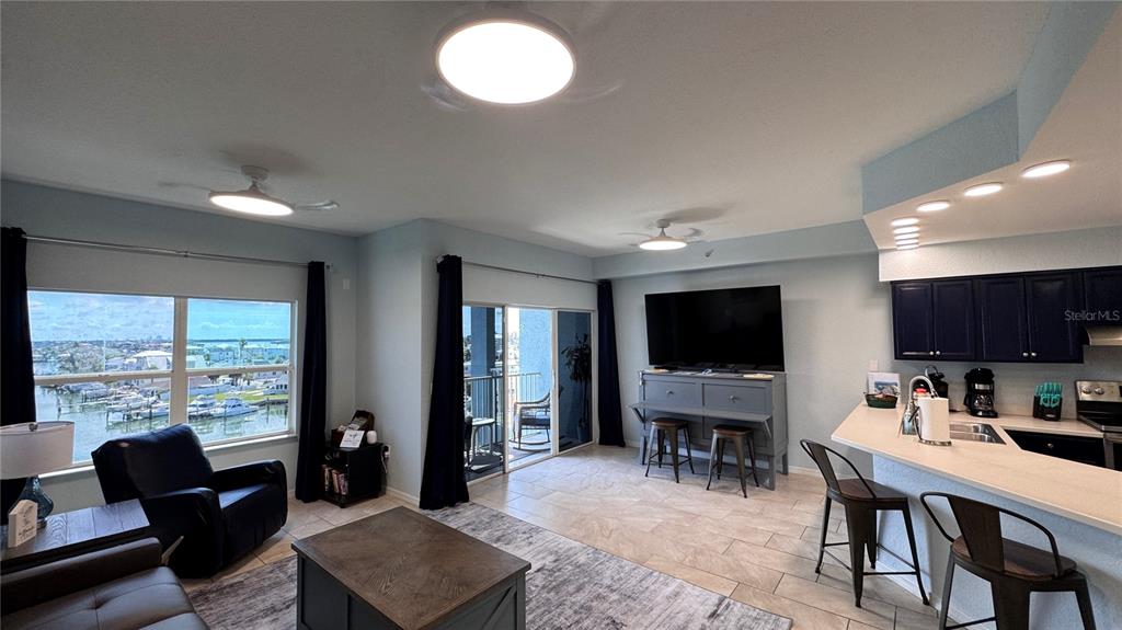 13999 Gulf Boulevard, Unit 501 Madeira Beach, FL 33708 - Photo 20 of 58 a living room with furniture and a flat screen tv