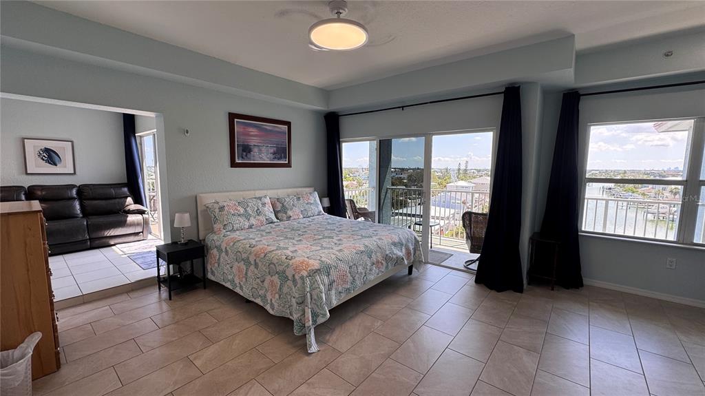 13999 Gulf Boulevard, Unit 501 Madeira Beach, FL 33708 - Photo 29 of 58 a bedroom with a bed and a large window