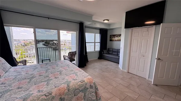 a living room with furniture and a floor to ceiling window
