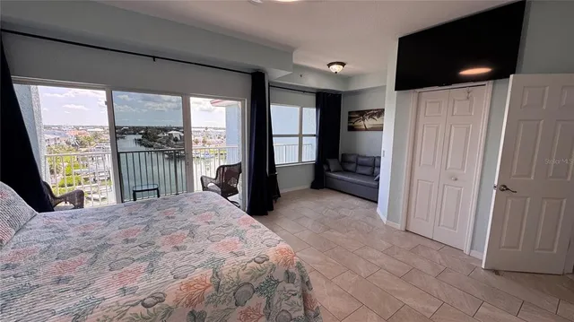 a living room with furniture and a floor to ceiling window