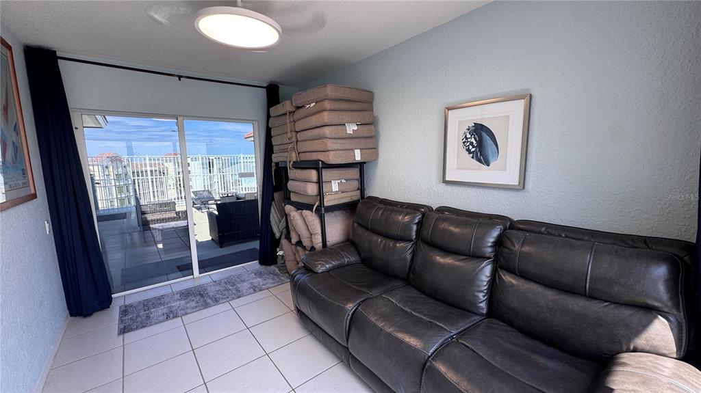 13999 Gulf Boulevard, Unit 501 Madeira Beach, FL 33708 - Photo 34 of 58 a living room with furniture and a large window