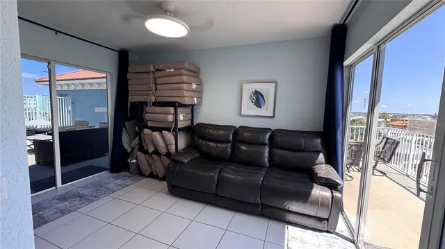 a living room with furniture floor to ceiling window and wooden floor