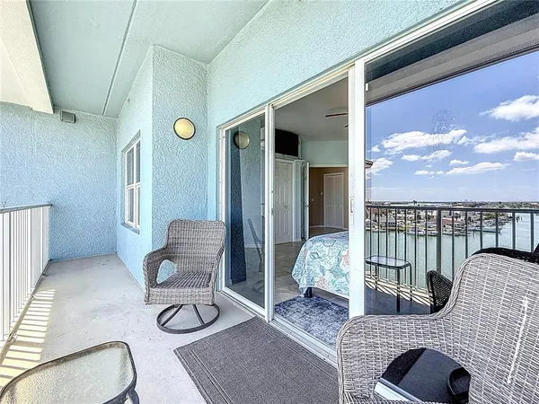 a bedroom with a bed and a flat tv screen on dresser