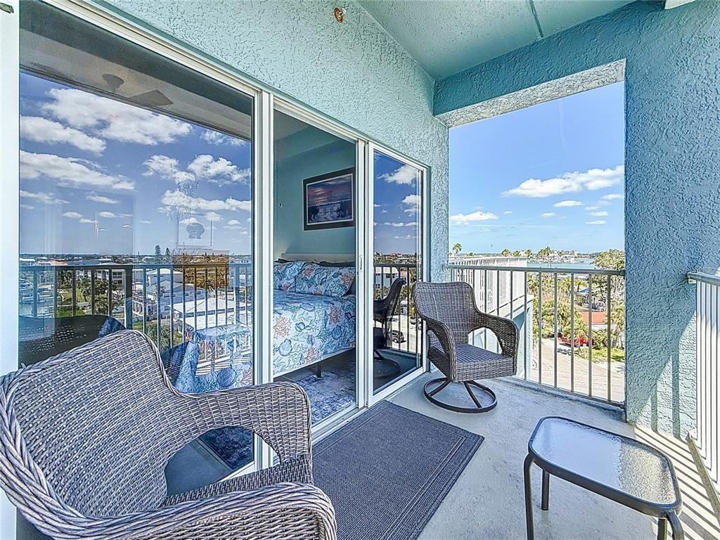13999 Gulf Boulevard, Unit 501 Madeira Beach, FL 33708 - Photo 39 of 58 a living room with furniture floor to ceiling window and wooden floor
