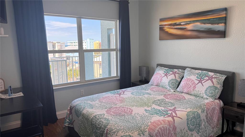 13999 Gulf Boulevard, Unit 501 Madeira Beach, FL 33708 - Photo 40 of 58 a large bed sitting in a bedroom next to a window