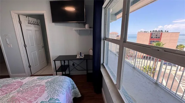 a bed sitting in a bedroom next to a window
