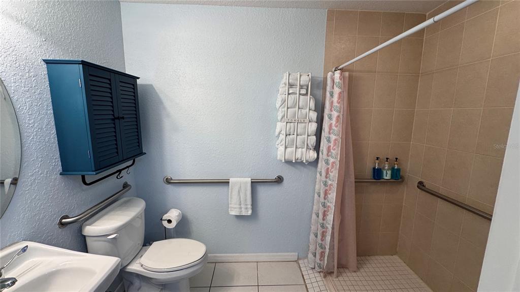 13999 Gulf Boulevard, Unit 501 Madeira Beach, FL 33708 - Photo 49 of 58 a bathroom with a toilet and shower