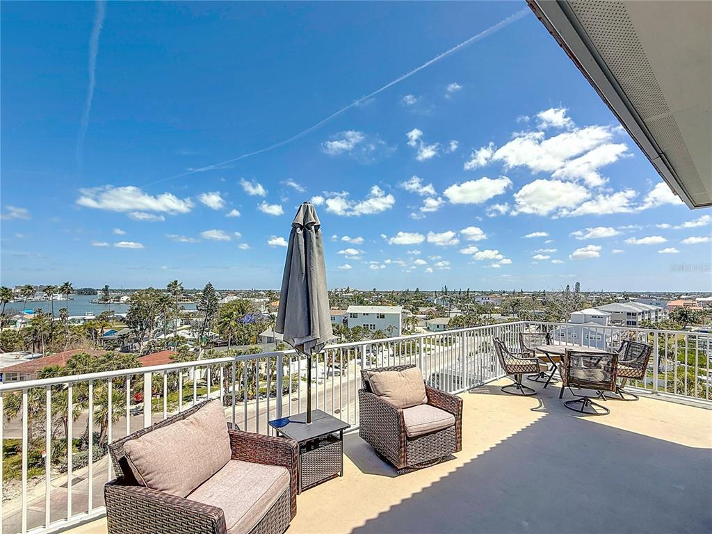 13999 Gulf Boulevard, Unit 501 Madeira Beach, FL 33708 - Photo 10 of 58 a view of a terrace with couches and city view